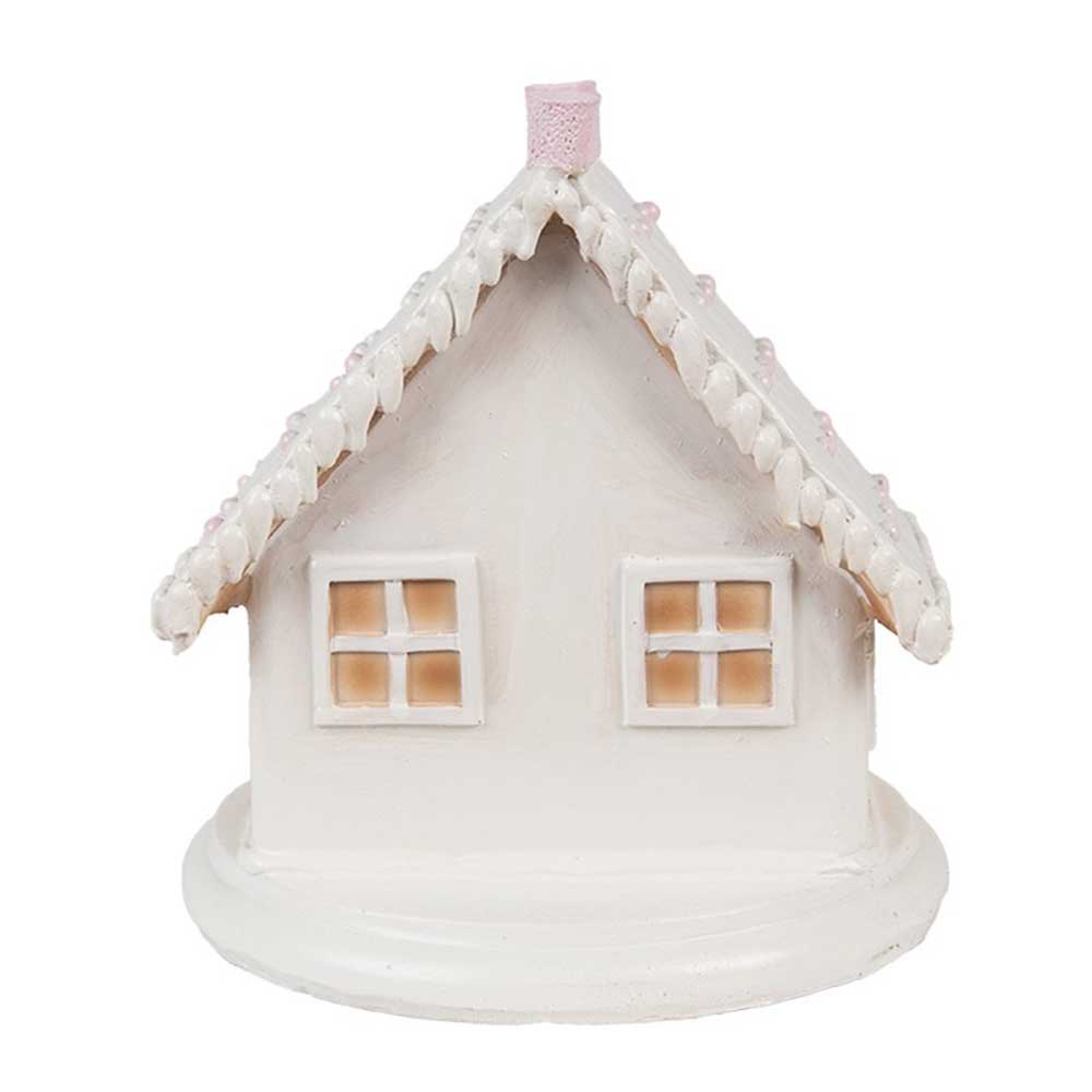 Das „Clayre &amp; Eef – Lebkuchenhaus mit LED 13 cm“ ist eine kleine, weiße Hausfigur aus Keramik mit einem steilen Dach, zwei quadratischen Fenstern und einem runden Sockel.